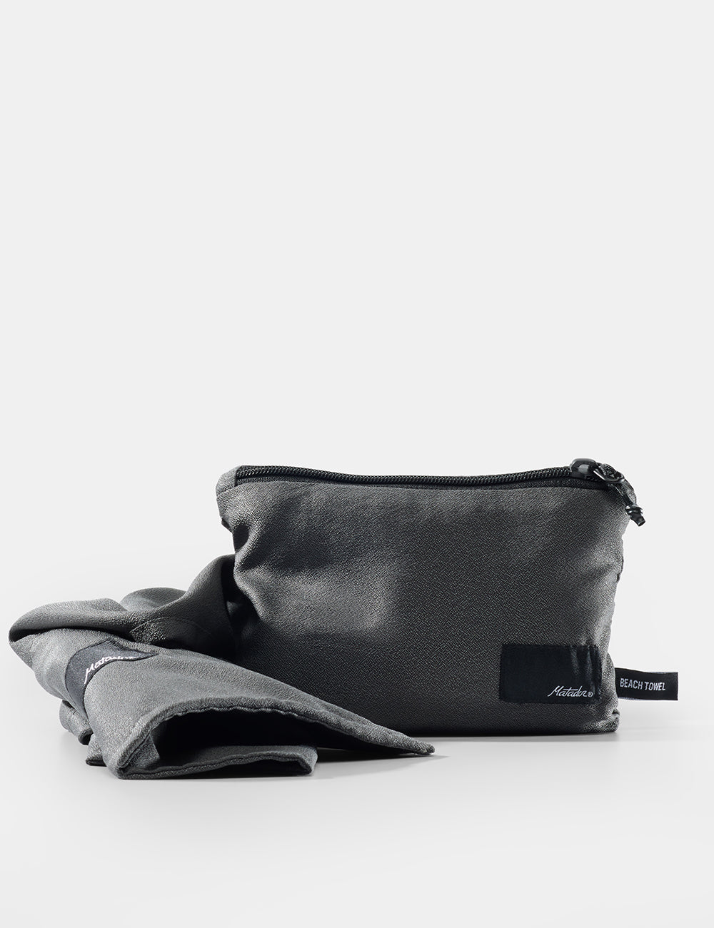Matador NanoDry™ Packable Beach Towel - gray pouch with a label on a white background