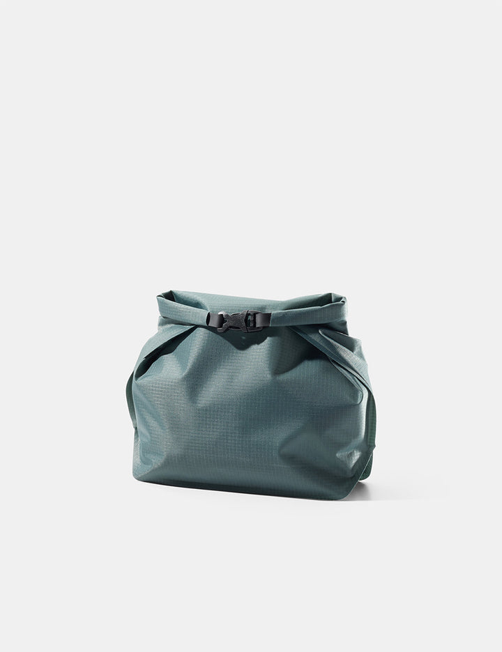 Matador FlatPak Waterproof Toiletry Case (V2) in Juniper - blue-green toiletry bag with a buckle on a light gray background