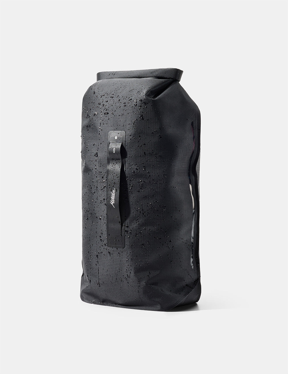 Matador FlatPak Drybag 8L (V2) in Black - black waterproof roll-top bag with water droplets on a white background