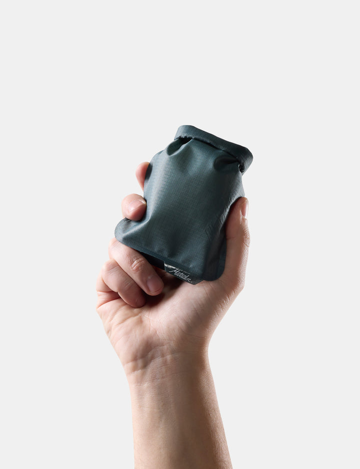 Matador FlatPak Travel Soap Bar Case (V2) in Juniper - hand holding Blue-green soap bar case against a light background