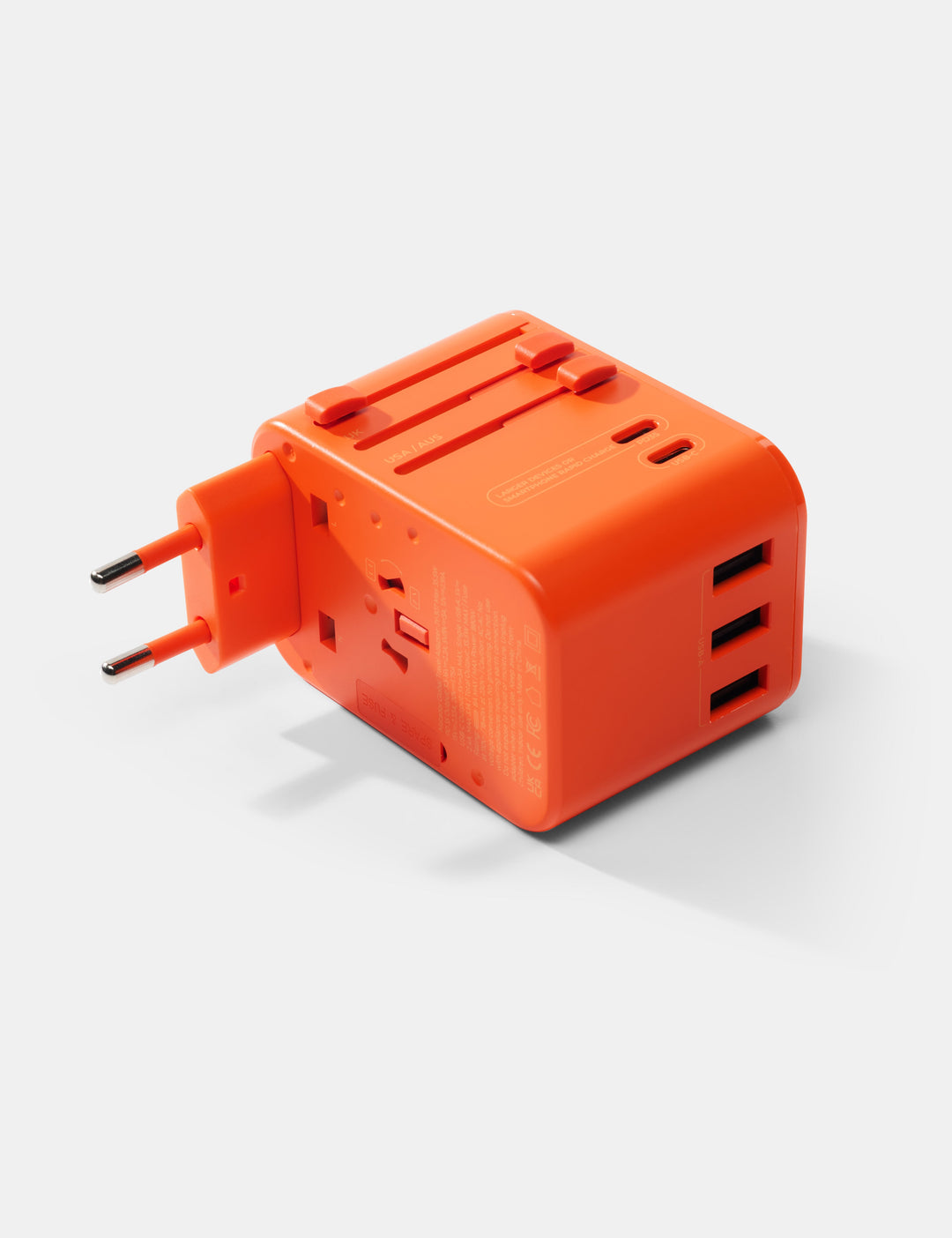Matador Global Travel Adapter in Orange - orange travel adapter with multiple ports on a white background