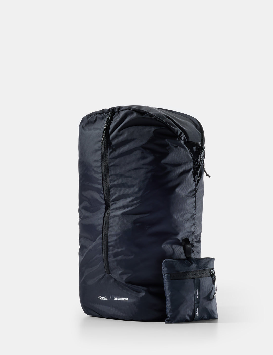 Matador Packable Laundry Bag - black laundry bag with a pocket on a white background