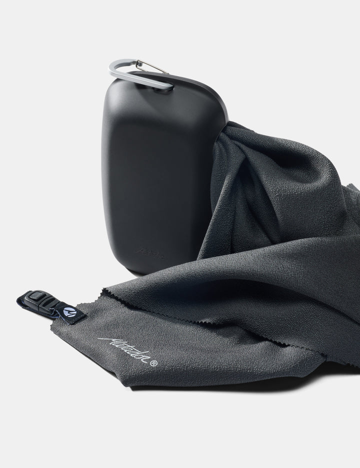 Matador NanoDry Towel - Large 132 x 60cm in Charcoal - gray towel and case with carabiner clip on a white background