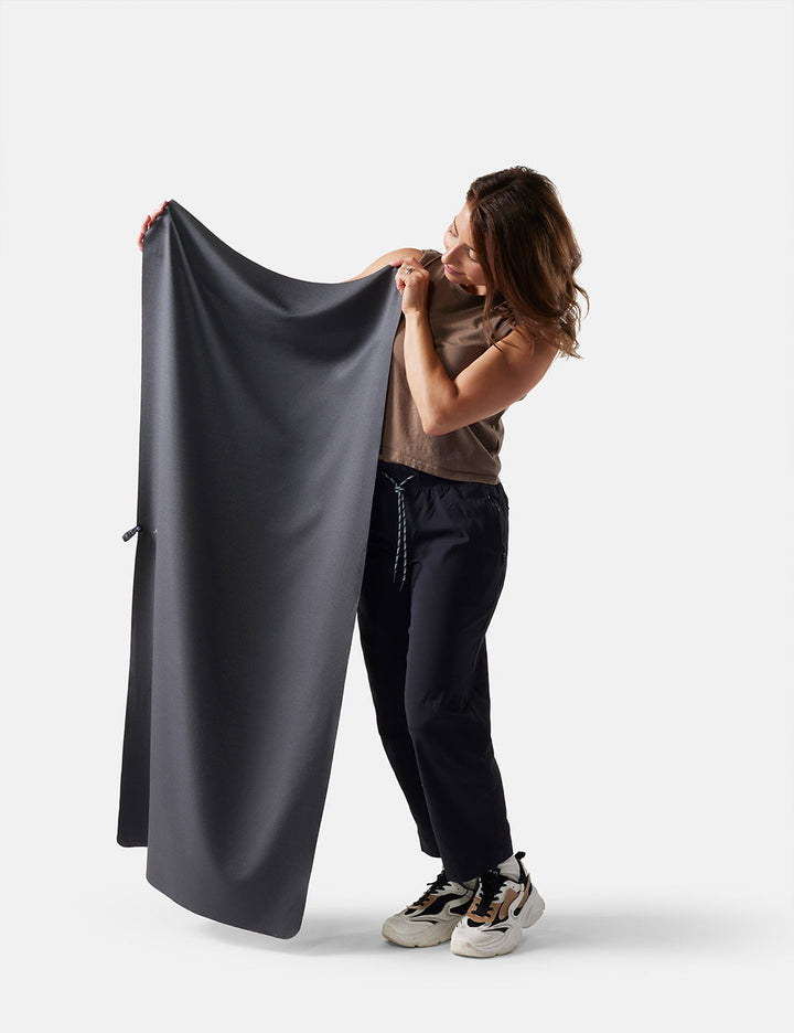 Matador NanoDry Towel - Large 132 x 60cm in Black Granite - person holding a large dark gray towel against a white background