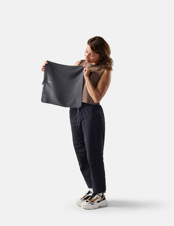Matador NanoDry Towel - Small 39 x 39cm in Charcoal - woman holding a black towel against a white background