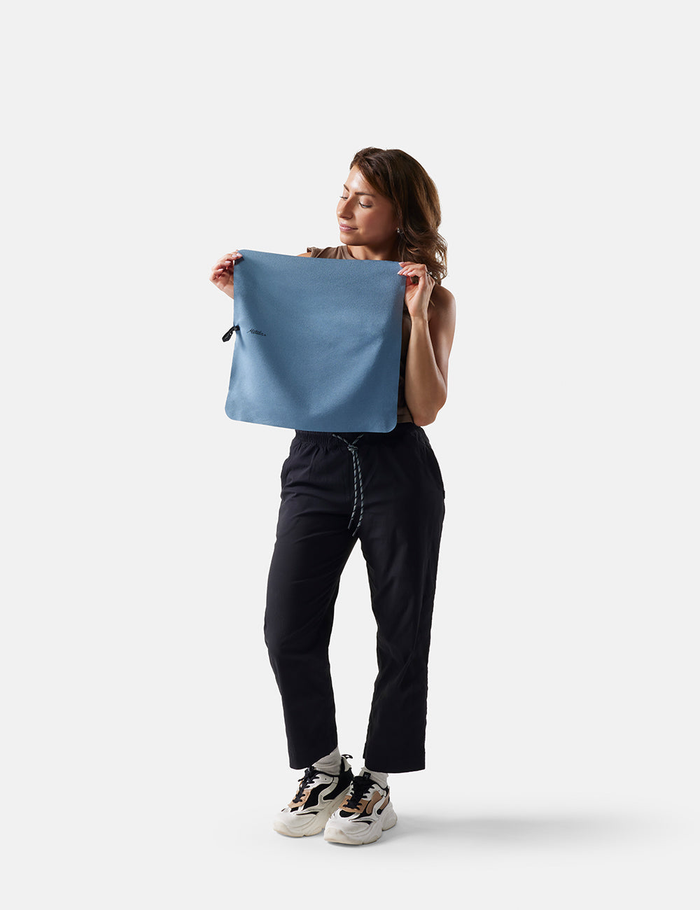 Matador NanoDry Towel - Small 39 x 39cm in Blue - woman holding slate towel against a white background