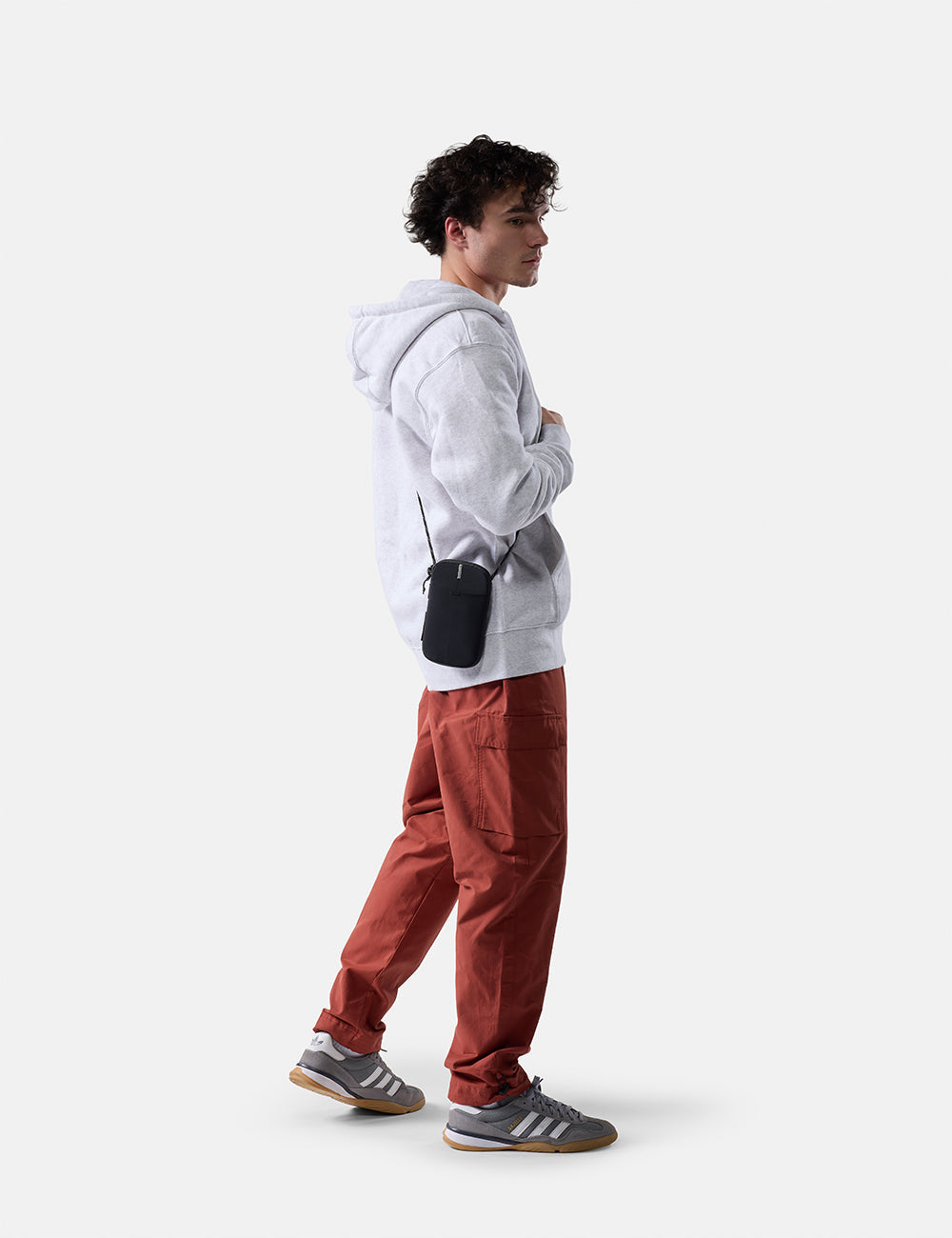 Matador Global Travel Stash in Black - man on white background wearing travel wallet cross body