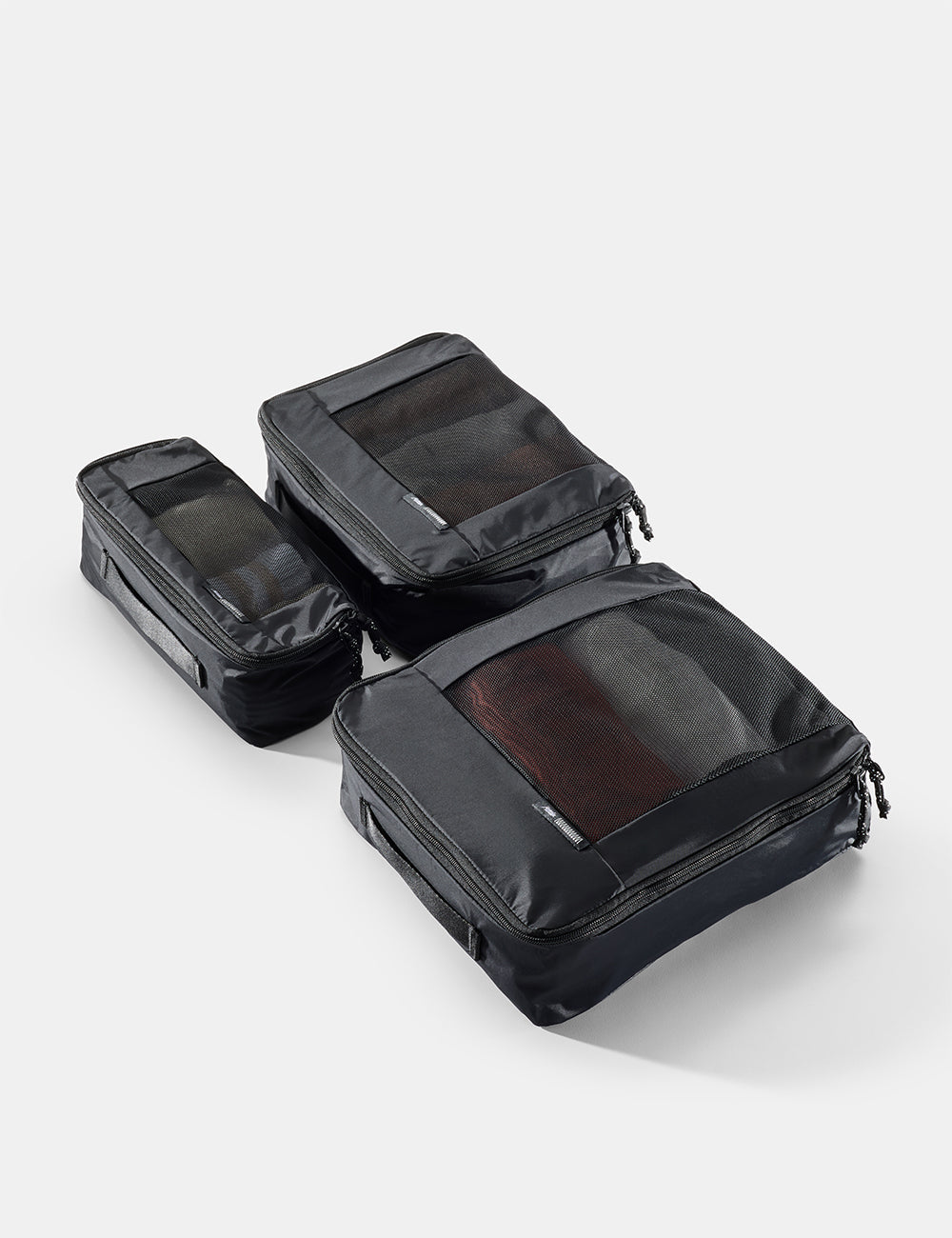 Matador Packing Cube Set (V2) in Black - set of black travel packing cubes on a light gray background