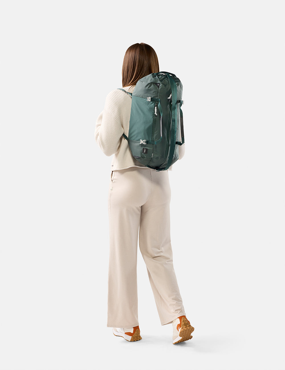 Matador 30L Packable Duffel in Juniper - person wearing a green backpack on a white background