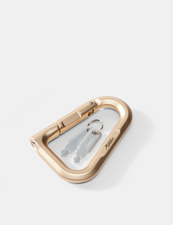 Matador BetaLock in Gold - gold carabiner with a keychain on a white background