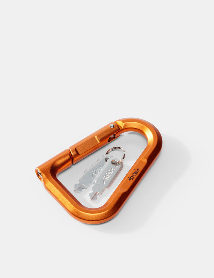 Matador BetaLock in Canyon Orange - orange carabiner with a key on a white background