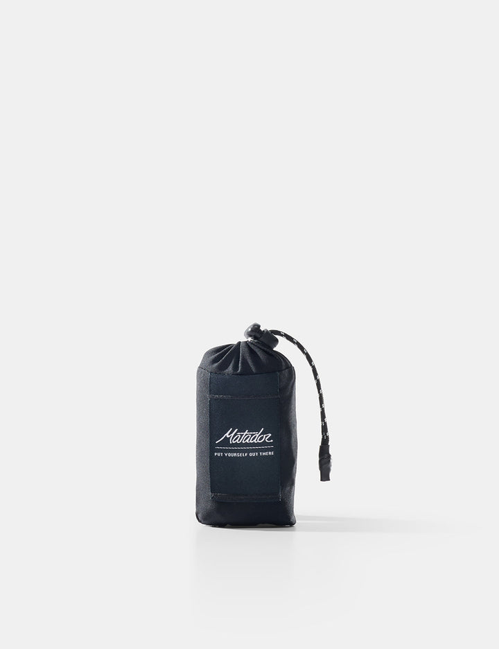 Matador Mini Pocket Blanket™ 4.0 - 110 x 70cm in Black - black drawstring pouch with brand logo on a white background