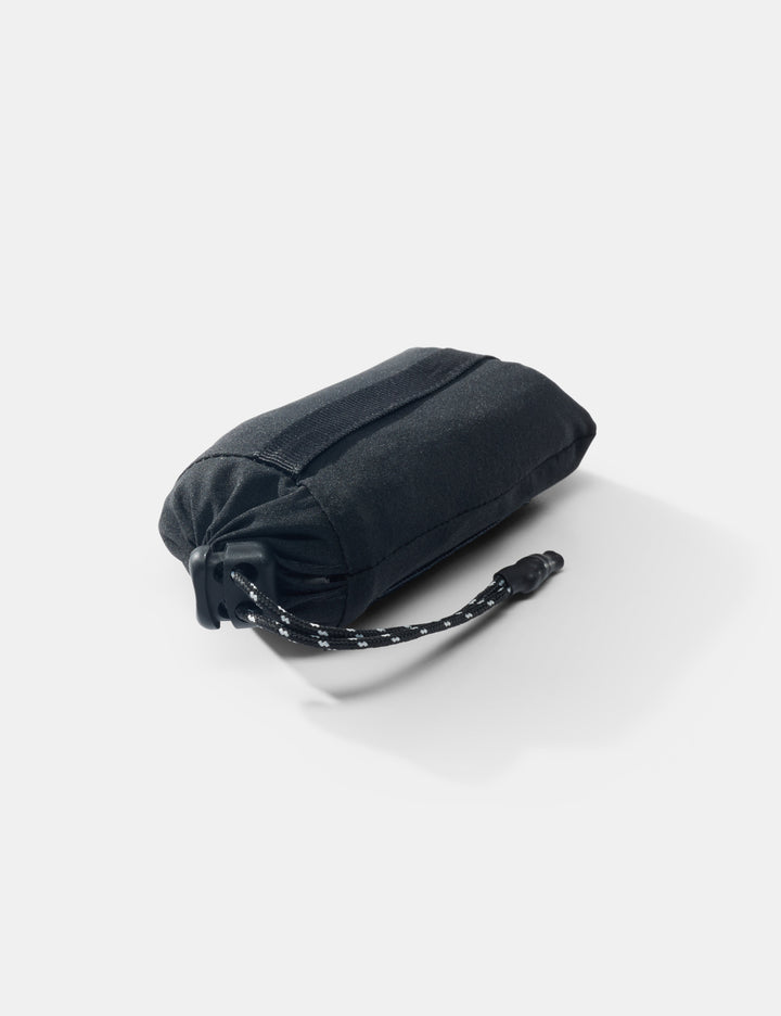 Matador Mini Pocket Blanket™ 4.0 - 110 x 70cm in Black - black folded bag with a strap on a white background