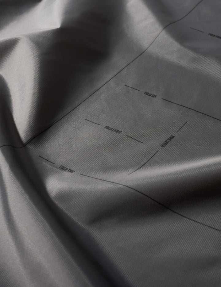 Matador Mini Pocket Blanket™ 4.0 - 110 x 70cm in Blue - close-up of gray fabric with subtle texture and folds