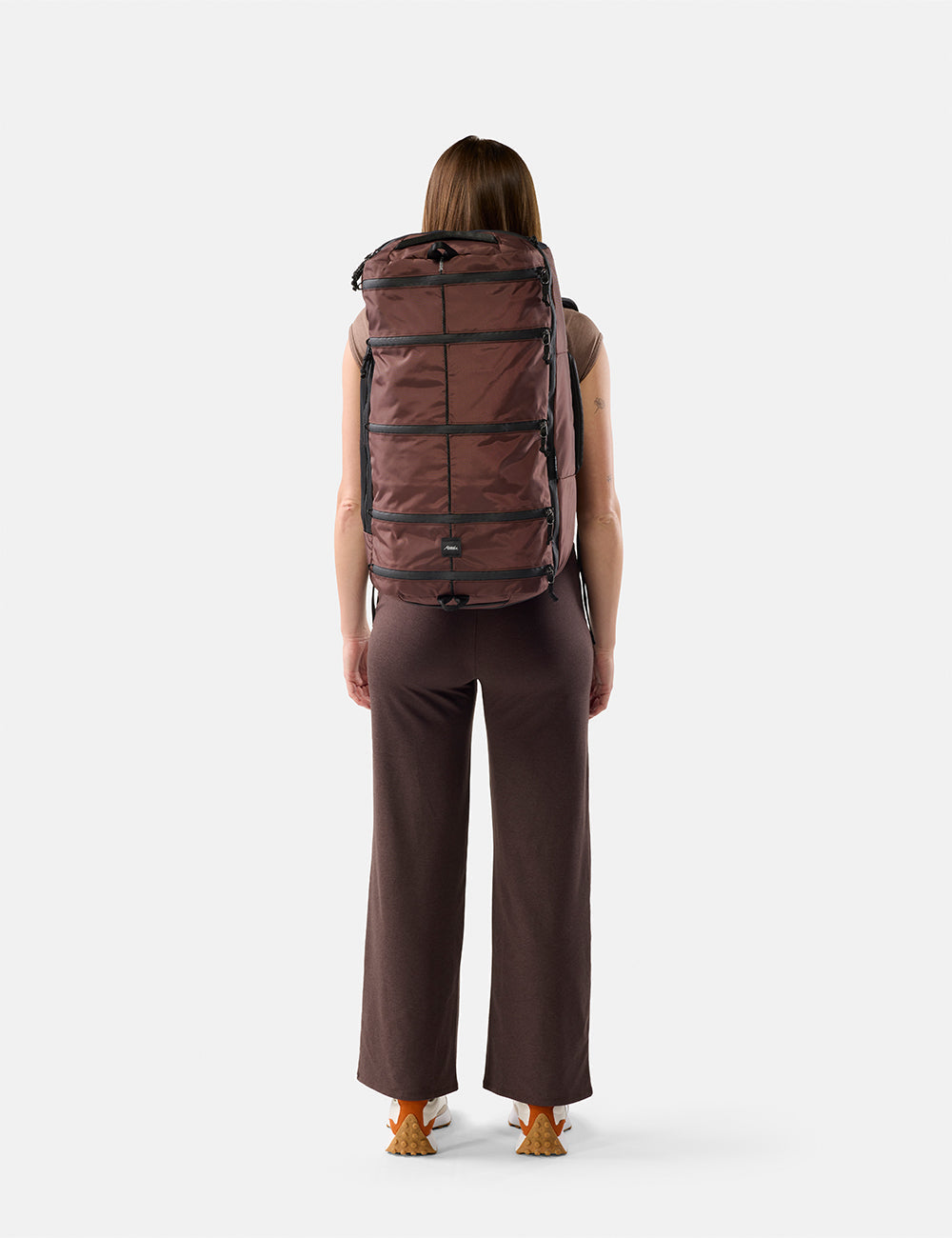 Matador 45L SEG Hybrid Travel Pack in Garnet - person wearing a large Garnet backpack on a white background