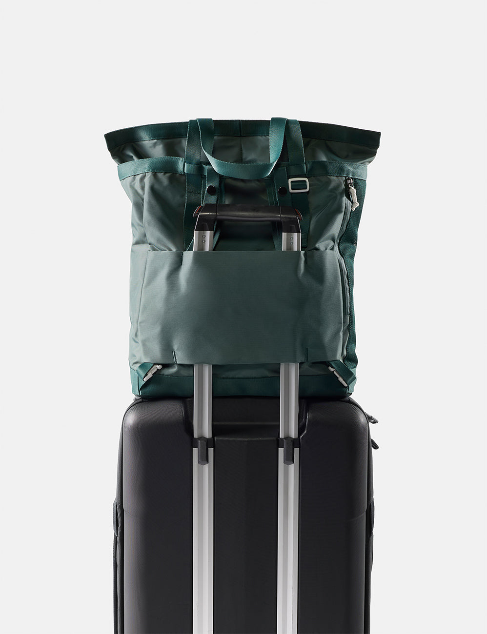 Matador 24L Tote Pack in Juniper - green tote pack on top of a black suitcase with a white background