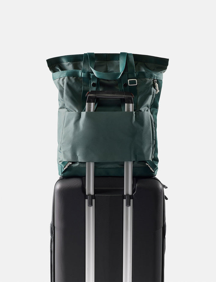Matador 24L Tote Pack in Juniper - green tote pack on top of a black suitcase with a white background