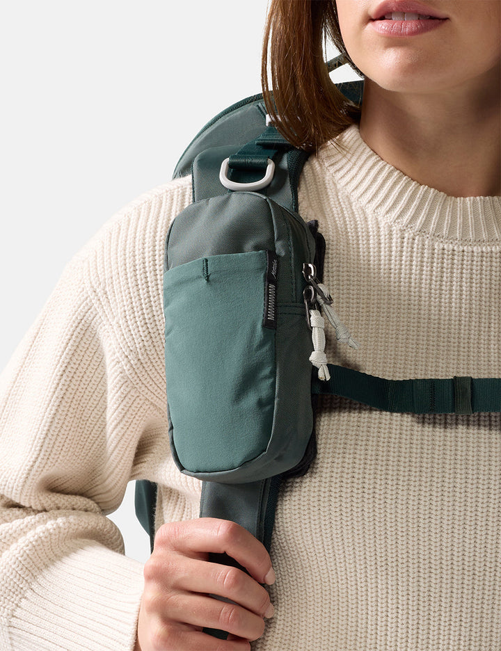 Matador Speed Stash (V2) in Juniper - person wearing a green backpack with a neutral background