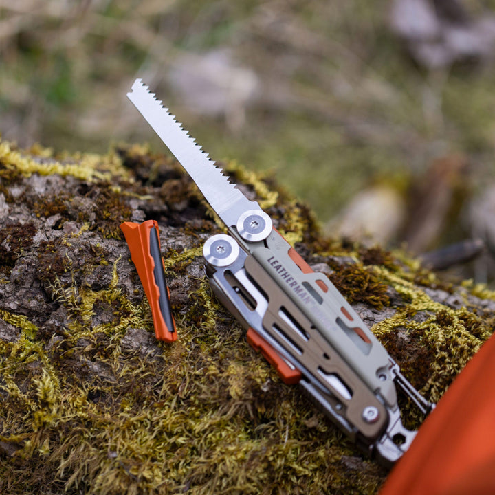 Leatherman Signal - saw deployed on a mossy log - Nitecore Singapore