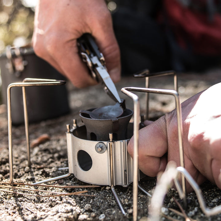 Leatherman Signal - pliers adjusting a camp stove - Nitecore Singapore